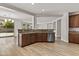 Open kitchen with stainless steel appliances, granite countertops, and light wood-look flooring at 3575 E Gary Way, Gilbert, AZ 85234