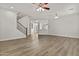 Open living area with wood-look floors, a view of the kitchen, and staircase access at 3575 E Gary Way, Gilbert, AZ 85234