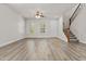 Bright and airy living room with wood floors, ceiling fan, and shuttered windows at 3575 E Gary Way, Gilbert, AZ 85234