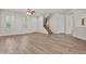 Inviting living room featuring wood-look floors, natural light, and staircase access at 3575 E Gary Way, Gilbert, AZ 85234