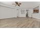 Expansive living room with light wood-look flooring and lots of space for entertaining or relaxing at 3575 E Gary Way, Gilbert, AZ 85234