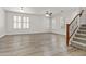 Spacious living area featuring wood-style flooring, bright windows, and a staircase at 3575 E Gary Way, Gilbert, AZ 85234