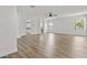 A bright, open living room featuring hard wood flooring, natural light, and a hallway at 3575 E Gary Way, Gilbert, AZ 85234