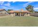 The backyard offers a lush lawn, privacy wall, and covered patio, a perfect space for relaxing or playing at 3882 S Hawthorn Dr, Chandler, AZ 85248