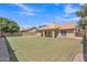 The home features a sprawling backyard with lush green grass and a covered patio, ideal for relaxation and outdoor activities at 3882 S Hawthorn Dr, Chandler, AZ 85248