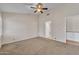 Carpeted bedroom featuring ceiling fan and ensuite bath with granite counters at 3882 S Hawthorn Dr, Chandler, AZ 85248