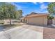 Single-story home with a tile roof, two-car garage, desert landscaping and a spacious driveway on a sunny day at 3882 S Hawthorn Dr, Chandler, AZ 85248