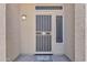 Close-up of a secure front door with a decorative security screen, sidelight and welcome mat at 3882 S Hawthorn Dr, Chandler, AZ 85248