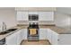 Updated kitchen features white cabinets, granite counters, and stainless steel appliances at 3882 S Hawthorn Dr, Chandler, AZ 85248