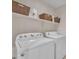 Functional laundry room with washer, dryer, shelving, and ample storage space at 3882 S Hawthorn Dr, Chandler, AZ 85248