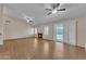 Large living room with wood-look tile floors, ceiling fans, and sliding glass doors that let in plenty of natural light at 3882 S Hawthorn Dr, Chandler, AZ 85248