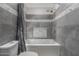 Bathroom featuring a bathtub, shower, and gray tiled walls at 428 S Sunnyvale --, Mesa, AZ 85206