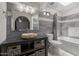 Bathroom with tiled walls, bathtub, and a sink with wooden storage underneath at 428 S Sunnyvale --, Mesa, AZ 85206