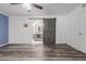 Bedroom featuring ceiling fan, wood look floors, and bathroom access through a sliding barn door at 428 S Sunnyvale --, Mesa, AZ 85206