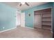 This bedroom features a ceiling fan, a door, and a spacious closet at 428 S Sunnyvale --, Mesa, AZ 85206