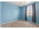 A comfortable bedroom with blue walls, carpeted floors, and a window with curtains at 428 S Sunnyvale --, Mesa, AZ 85206