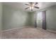A green bedroom features a ceiling fan, carpet, and a window at 428 S Sunnyvale --, Mesa, AZ 85206