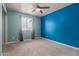 Well lit bedroom with blue walls, a ceiling fan, and large window at 428 S Sunnyvale --, Mesa, AZ 85206