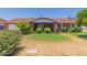 Charming single-story home with a brick facade, covered porch, and mature landscaping at 428 S Sunnyvale --, Mesa, AZ 85206