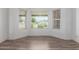 Bright living room featuring neutral walls, wood floors, and large windows providing ample natural light and pleasant views at 428 S Sunnyvale --, Mesa, AZ 85206