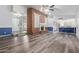 Spacious living room with wood flooring, brick fireplace, and an open concept design that flows into the kitchen at 428 S Sunnyvale --, Mesa, AZ 85206