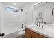 A remodeled bathroom with tiled shower and quartz countertop vanity at 4439 W Cielo Grande --, Glendale, AZ 85310