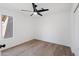 Empty bedroom with wood floors, ceiling fan, and window view of outside landscape at 4439 W Cielo Grande --, Glendale, AZ 85310
