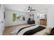 Bright bedroom with hardwood floors, large window, and view to ensuite bath at 4439 W Cielo Grande --, Glendale, AZ 85310