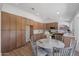 Bright kitchen features wood cabinets, white counters, and a round breakfast table with marble top at 4439 W Cielo Grande --, Glendale, AZ 85310