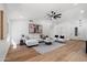 Spacious living room with wood-look floors, modern fan, and neutral tones offers a cozy and inviting atmosphere at 4439 W Cielo Grande --, Glendale, AZ 85310