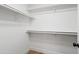 Empty walk-in closet with white walls, white closet rods and door hardware at 4439 W Cielo Grande --, Glendale, AZ 85310