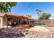 Spacious backyard with covered patio, lounge chairs, and a refreshing swimming pool at 5354 E Ellis St, Mesa, AZ 85205