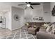 Cozy living room with neutral tones, featuring a large sectional sofa, modern fan, and open layout at 5354 E Ellis St, Mesa, AZ 85205