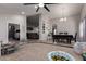 Spacious living area with modern fan, seamlessly flowing into the dining area with carpet and tile flooring at 5354 E Ellis St, Mesa, AZ 85205