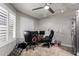 Bright home office features dual workstations, overhead lighting, and natural light from shuttered windows at 5354 E Ellis St, Mesa, AZ 85205