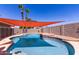 Sparkling swimming pool features a sunshade, -proof safety fence, and palm trees in the background at 5354 E Ellis St, Mesa, AZ 85205