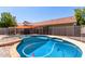 Inviting backyard pool with safety fence, pink flamingo, and charming desert landscaping at 5354 E Ellis St, Mesa, AZ 85205