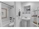 Bright bathroom with a pedestal sink, white tile in the shower-tub and a decorative mirror at 7557 N Dreamy Draw Dr # 154, Phoenix, AZ 85020