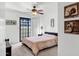 Bright bedroom with a ceiling fan, sliding glass doors and light pink bedspread at 7557 N Dreamy Draw Dr # 154, Phoenix, AZ 85020