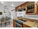 The kitchen features stainless steel appliances, stone countertops and an open access to the dining room at 7557 N Dreamy Draw Dr # 154, Phoenix, AZ 85020