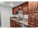 Kitchen with stone countertops, wooden cabinets and stainless steel appliances, featuring a double sink at 7557 N Dreamy Draw Dr # 154, Phoenix, AZ 85020