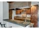 Close-up of the kitchen with stone countertops, stainless steel appliances, and dark wood cabinets at 7557 N Dreamy Draw Dr # 154, Phoenix, AZ 85020