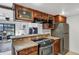 Kitchen featuring stainless steel appliances, stone countertops, and open access to the living room at 7557 N Dreamy Draw Dr # 154, Phoenix, AZ 85020
