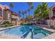Beautiful community pool and spa surrounded by lush palm trees and meticulously landscaped grounds at 7557 N Dreamy Draw Dr # 154, Phoenix, AZ 85020
