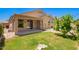 Inviting backyard featuring a covered patio, lush lawn and secure fence, perfect for outdoor enjoyment and privacy at 9142 W Pontiac Dr, Peoria, AZ 85382