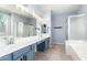 Spacious bathroom featuring a double vanity, large mirror, and separate shower and tub at 9142 W Pontiac Dr, Peoria, AZ 85382