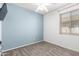 Bright bedroom featuring carpet floors, ceiling fan and a window at 9142 W Pontiac Dr, Peoria, AZ 85382