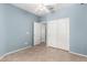 Bedroom with tile flooring, white closet doors, and a ceiling fan at 9142 W Pontiac Dr, Peoria, AZ 85382