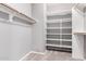 Walk-in closet with built-in shelving and rods for ample storage at 9142 W Pontiac Dr, Peoria, AZ 85382