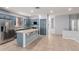 An open kitchen boasts a large island, stainless steel appliances, and blue cabinets at 9142 W Pontiac Dr, Peoria, AZ 85382